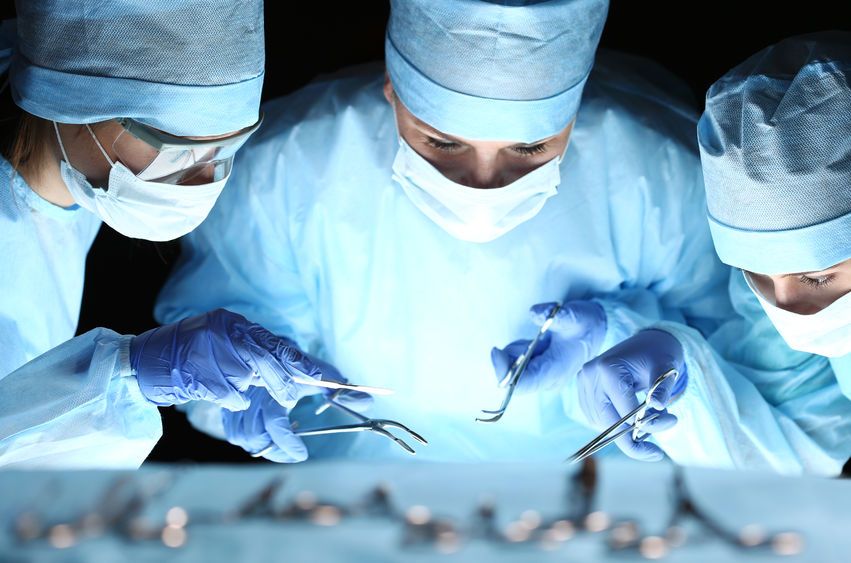Doctores utilizando instrumentos quirúrgicos 